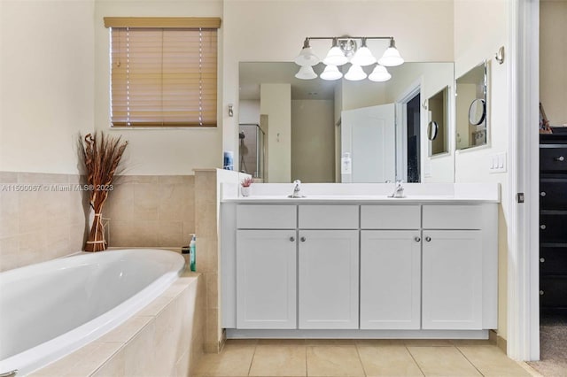 bathroom featuring vanity, tile patterned floors, and separate shower and tub