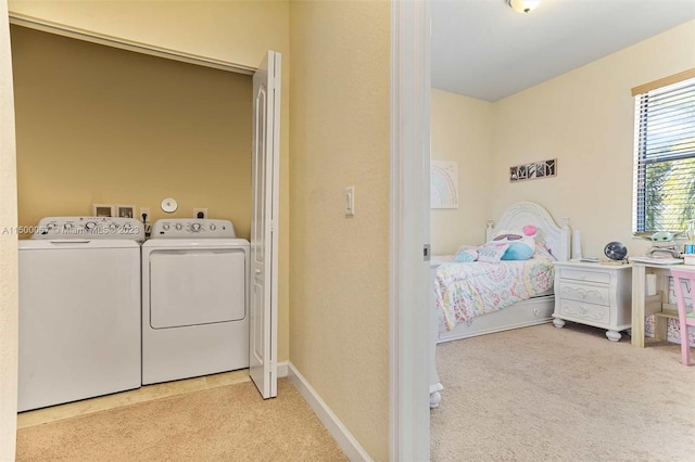 laundry room with carpet floors and separate washer and dryer