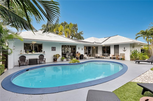 view of pool featuring an outdoor living space and a patio