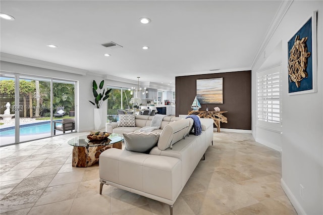 living room with a chandelier and crown molding