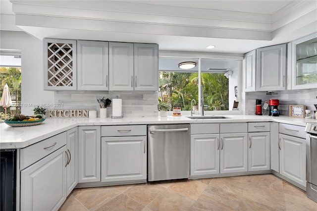 kitchen with gray cabinets, sink, plenty of natural light, and appliances with stainless steel finishes