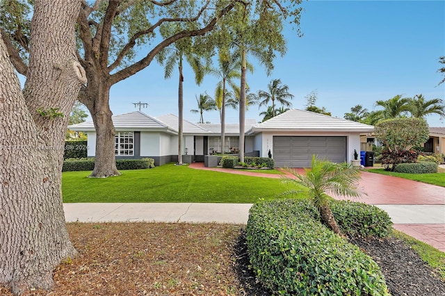 single story home featuring a garage and a front yard