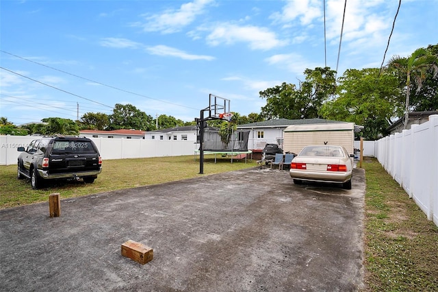 manufactured / mobile home with a front yard and a trampoline