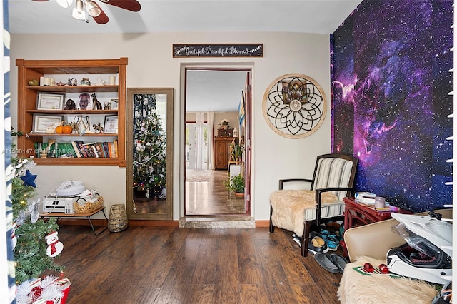 living area featuring ceiling fan and dark hardwood / wood-style flooring