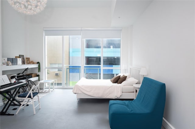 bedroom featuring concrete floors and a notable chandelier