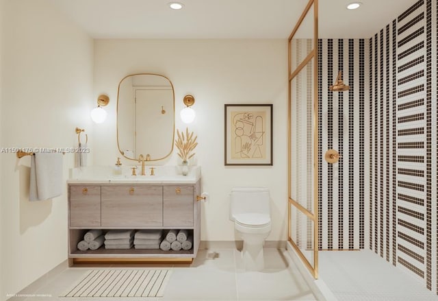 bathroom featuring tiled shower, vanity, toilet, and tile patterned flooring