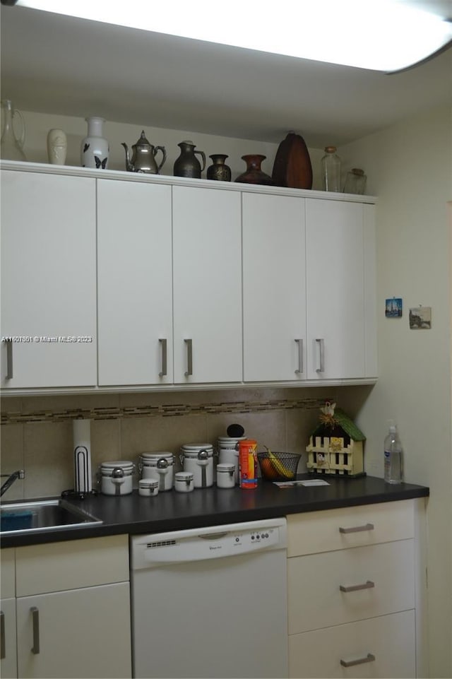 kitchen with white cabinets, dishwasher, sink, and decorative backsplash