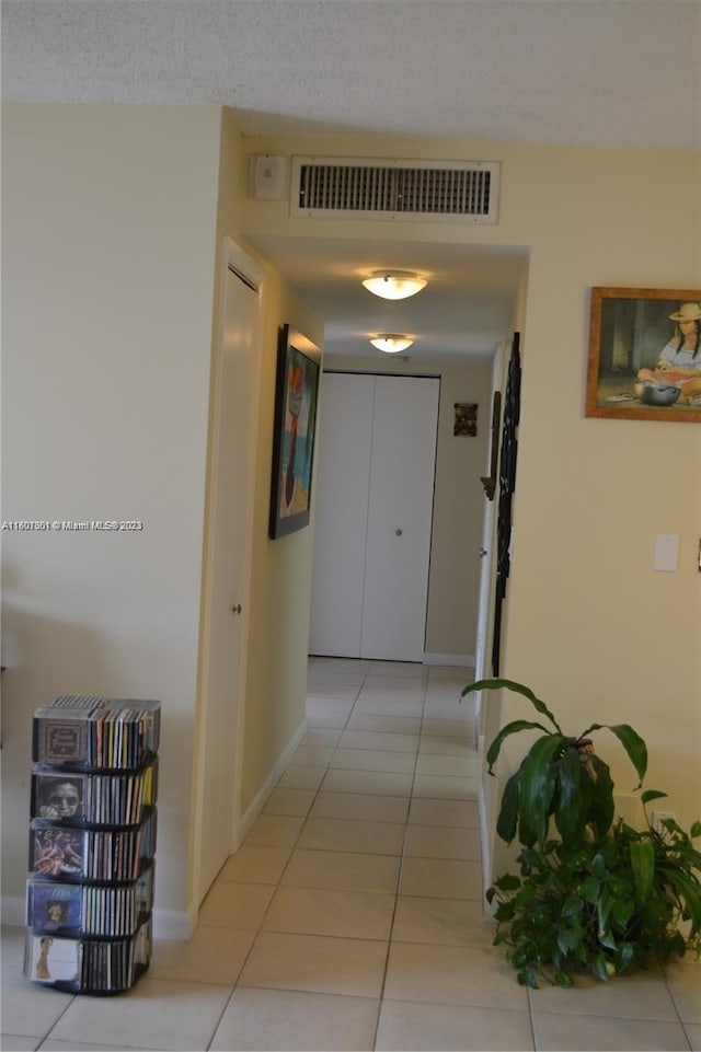 corridor featuring light tile patterned floors