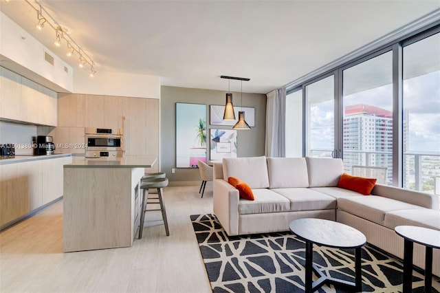 4010 S Ocean Dr Unit R2106, Hollywood, FL 33019 - living area with rail lighting, visible vents, a city view, and light wood finished floors