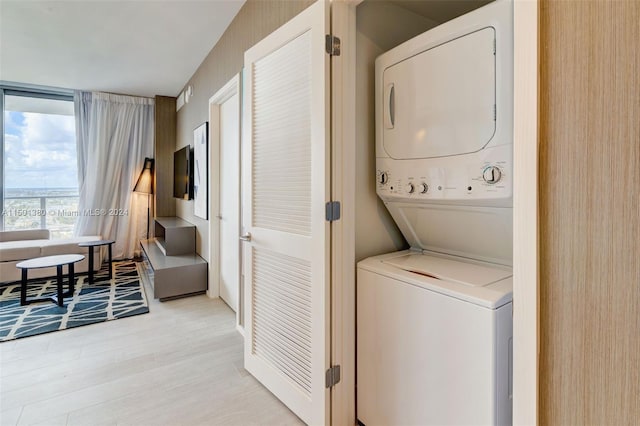 4010 S Ocean Dr Unit R2106, Hollywood, FL 33019 - clothes washing area with light wood-type flooring, laundry area, and stacked washer / drying machine
