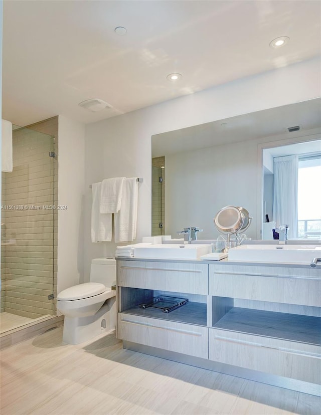 full bathroom featuring dual bowl vanity, tile patterned floors, plus walk in shower, and toilet