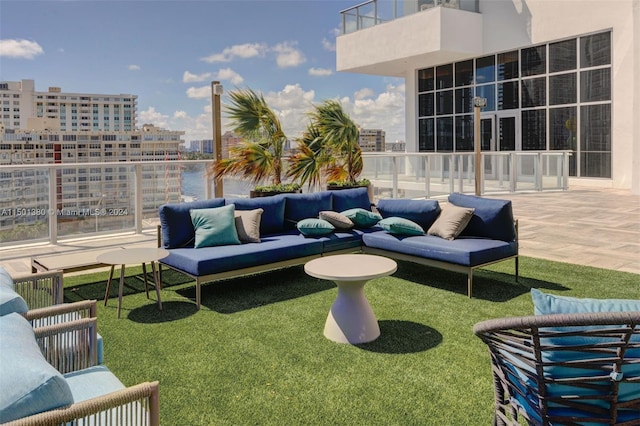 view of yard with outdoor lounge area and a balcony