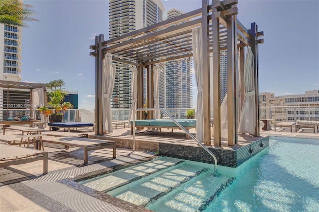 view of pool with a pergola and a patio