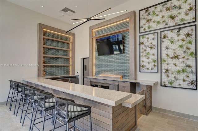 bar featuring ceiling fan and light tile patterned floors