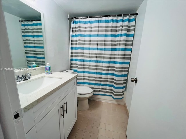 bathroom featuring vanity, tile patterned flooring, and toilet