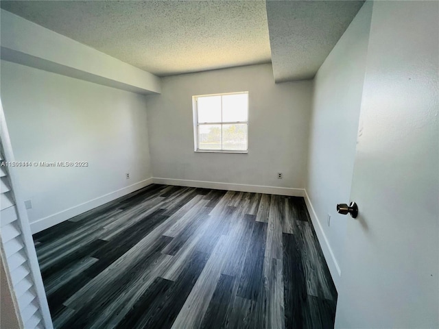 unfurnished room featuring a textured ceiling and hardwood / wood-style floors