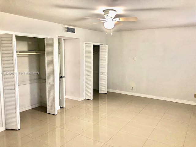 9633 SW 20th Ter Unit 9633, Miami, FL 33165 - unfurnished bedroom featuring tile patterned flooring, multiple closets, baseboards, and ceiling fan