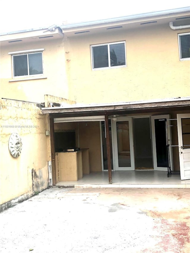 9633 SW 20th Ter Unit 9633, Miami, FL 33165 - rear view of property featuring stucco siding and a patio
