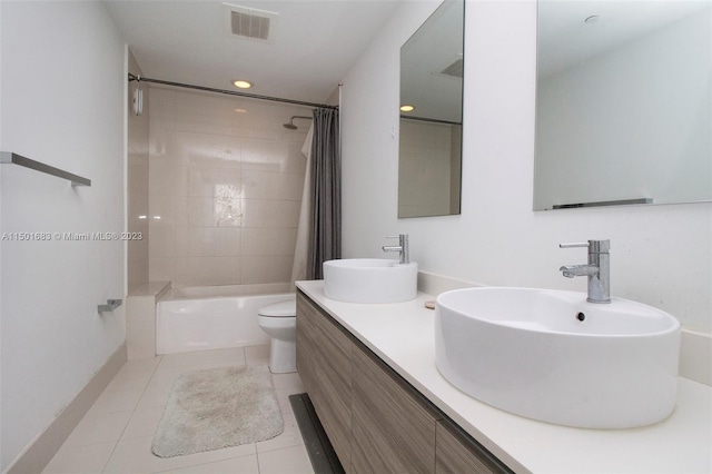 full bathroom with shower / bath combo, tile floors, dual sinks, toilet, and oversized vanity