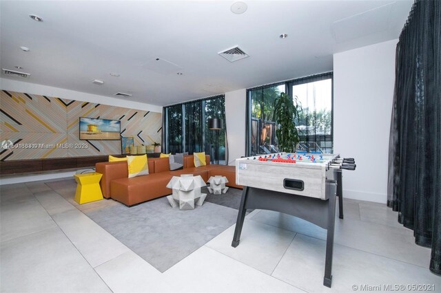 recreation room with light tile flooring