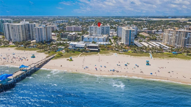 drone / aerial view featuring a view of the beach and a water view