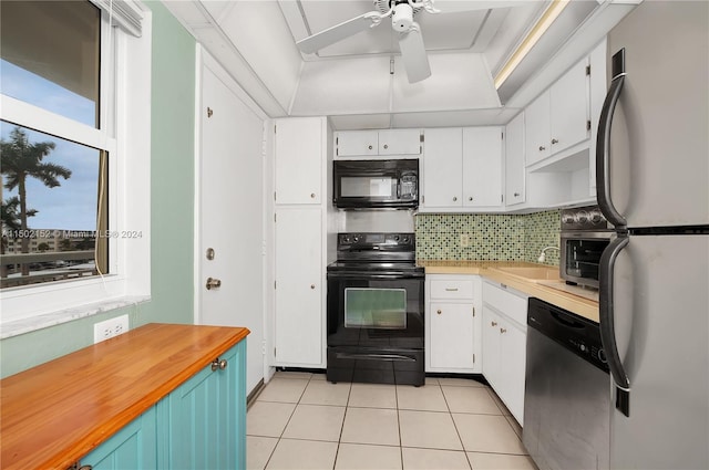 kitchen featuring black appliances, ceiling fan, light tile patterned floors, tasteful backsplash, and white cabinetry