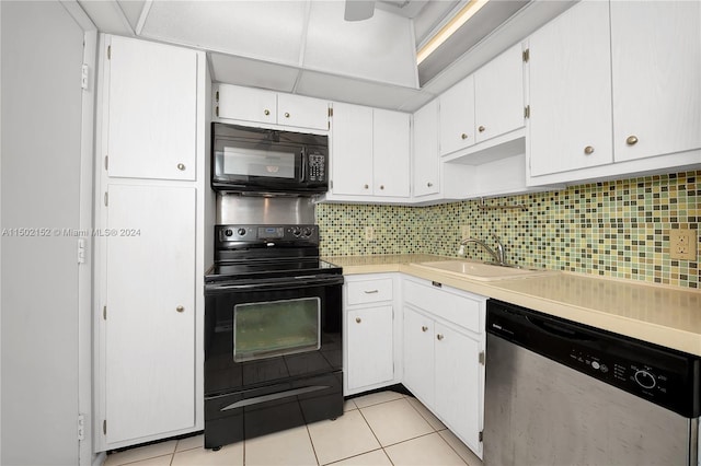 kitchen featuring white cabinets, light tile patterned floors, sink, and black appliances