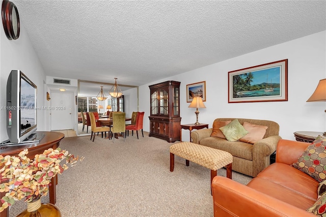 living room featuring a textured ceiling and carpet floors