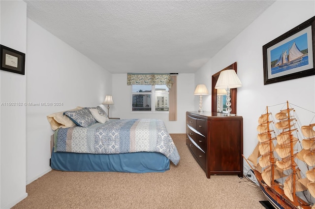 carpeted bedroom featuring a textured ceiling