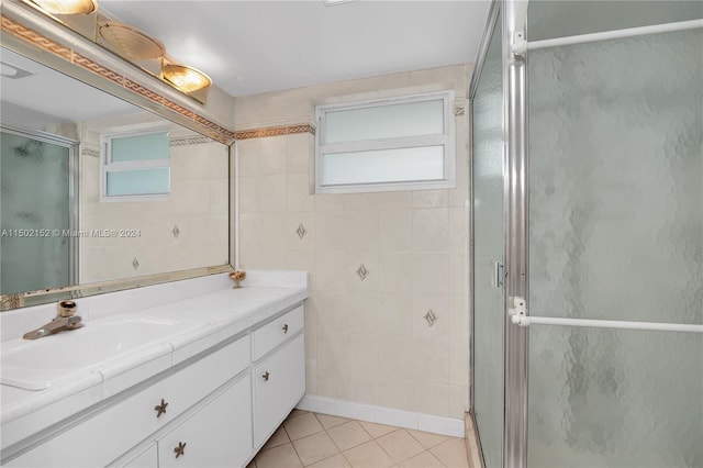 bathroom featuring vanity, tile patterned floors, and a shower with door