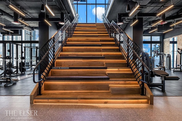 staircase featuring dark tile flooring