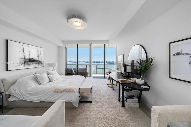 bedroom with wood-type flooring, access to outside, and floor to ceiling windows