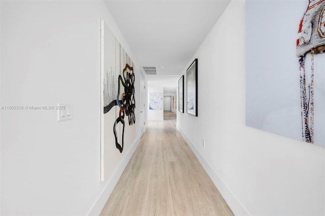 hall with light hardwood / wood-style floors