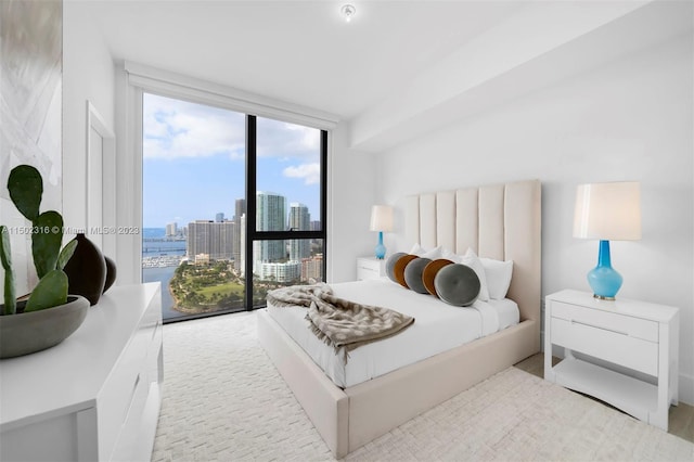 bedroom featuring a wall of windows and access to exterior