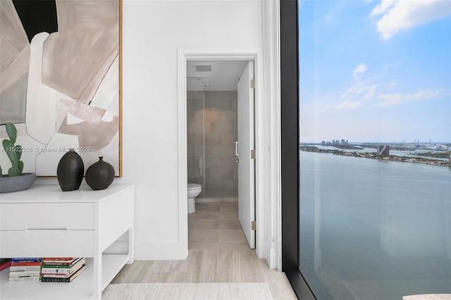 bathroom featuring toilet and a water view