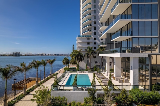 view of swimming pool with a patio and a water view