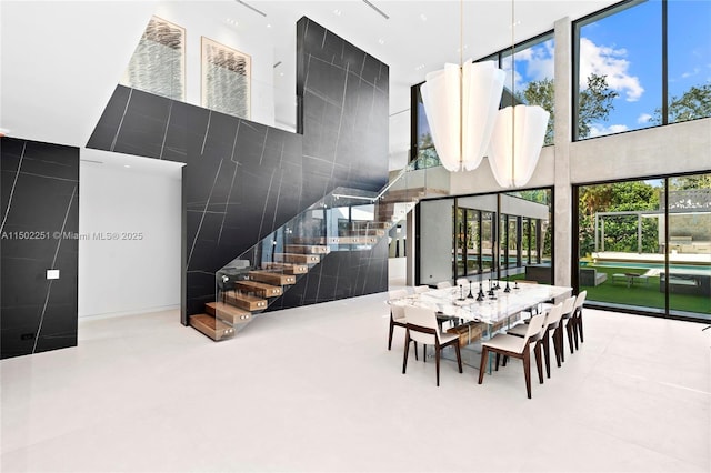 dining space featuring a towering ceiling