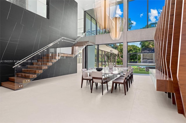 dining area with a high ceiling and plenty of natural light