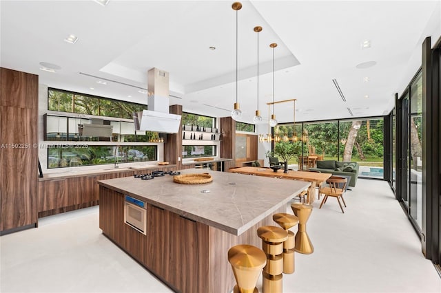 5245 Oak Ln, Coral Gables, FL 33156 - kitchen featuring modern cabinets, a spacious island, open floor plan, pendant lighting, and gas stovetop
