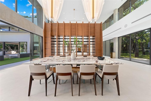 dining space featuring a towering ceiling