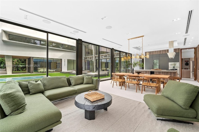 5245 Oak Ln, Coral Gables, FL 33156 - living area with a wall of windows, a chandelier, and plenty of natural light