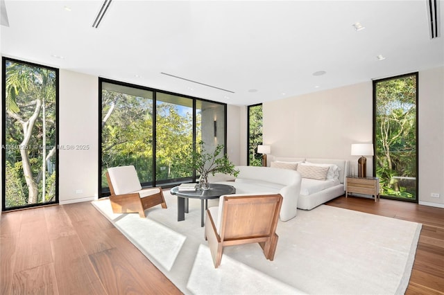 5245 Oak Ln, Coral Gables, FL 33156 - living room featuring expansive windows, healthy amount of natural light, and light wood-style floors
