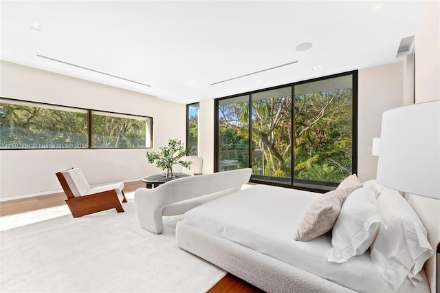 5245 Oak Ln, Coral Gables, FL 33156 - bedroom with wood finished floors and a wall of windows
