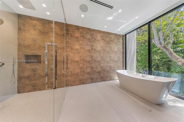 5245 Oak Ln, Coral Gables, FL 33156 - bathroom featuring a shower with door and a soaking tub
