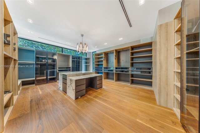 5245 Oak Ln, Coral Gables, FL 33156 - walk in closet with light wood finished floors and a chandelier