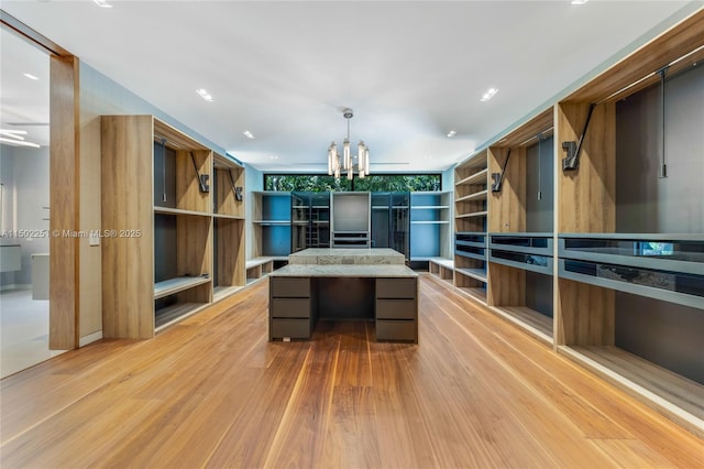 5245 Oak Ln, Coral Gables, FL 33156 - spacious closet with a chandelier, built in study area, and light wood-type flooring