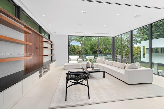 living room featuring a wall of windows and a healthy amount of sunlight