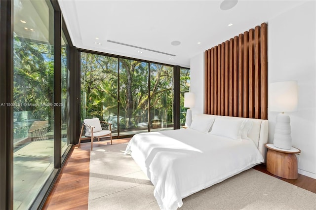 5245 Oak Ln, Coral Gables, FL 33156 - bedroom featuring floor to ceiling windows and wood finished floors