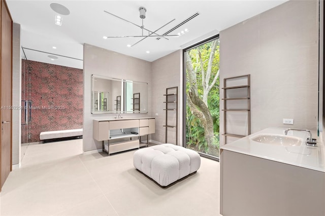 bathroom featuring vanity, tile patterned floors, floor to ceiling windows, and an inviting chandelier