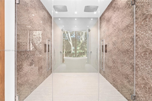 bathroom featuring a shower with shower door and tile patterned flooring